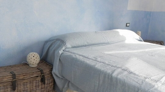 De slaapkamer van naturistische accommodatie Locanda di Terramare