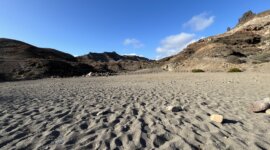Naaktstrand Playa de Medio Almud is een donker zandstrand in een baai op Gran Canaria