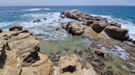 Zwemmen in kristalhelder water tussen de rotsen bij Naaktstrand Paraga Beach op Mykonos Griekenland