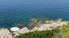 Zicht over de rotsen naar de blauwe zee op Naaktstrand Hotel Croatia Cavtat